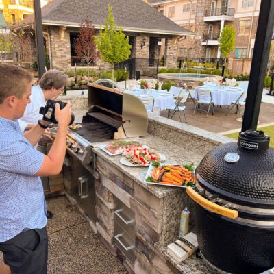 Photographer shoots food near outdoor grill