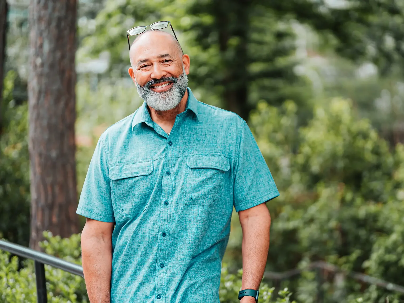 Man in short sleeve button down smiling at camera.