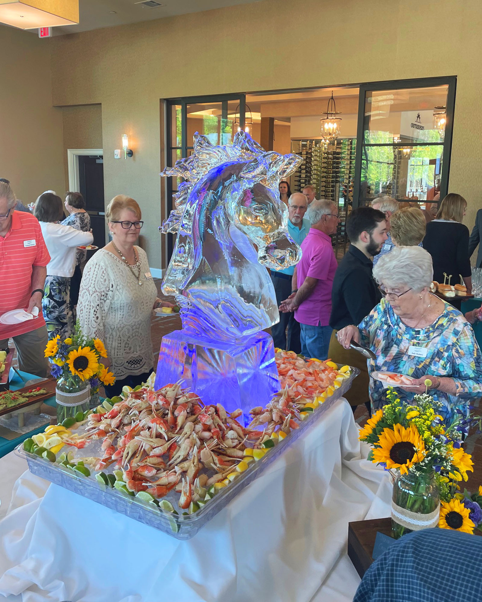 An ice sculpture around a large display of crab claws