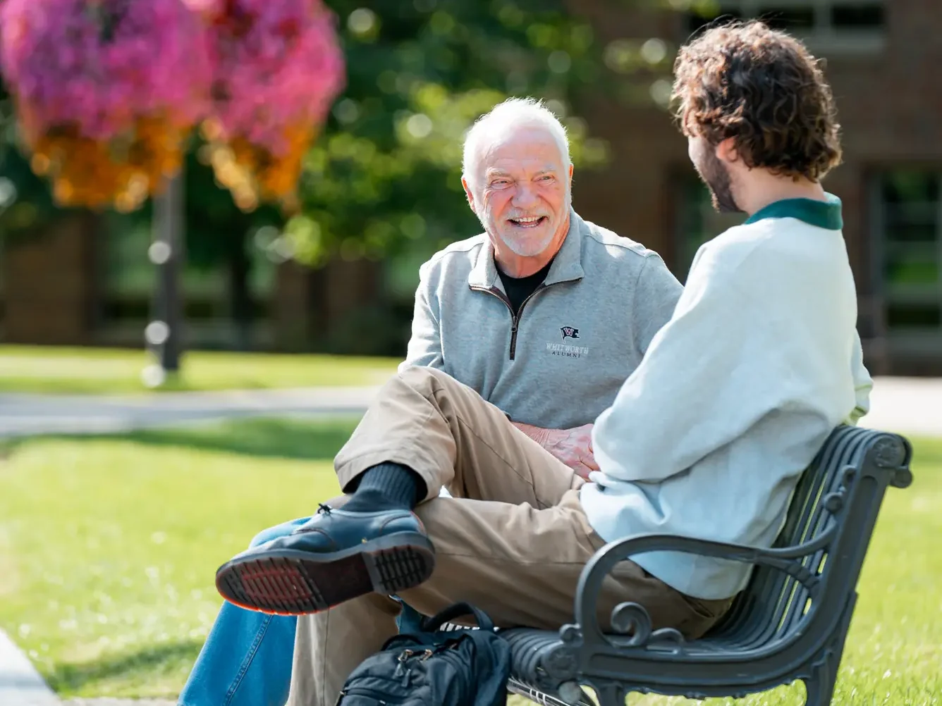 Rockwood resident sitting on a bench with a Whitworth student.